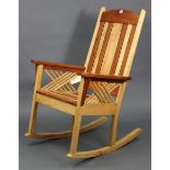 A Tamarack maple & cherry wood rocking chair with slatted seat & back, & on square supports.