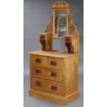 A late Victorian walnut small dressing chest, with rectangular bevelled mirror to the stage back,