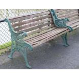 A Victorian-style garden bench with teak slatted seat & back, & on green painted cast-metal end