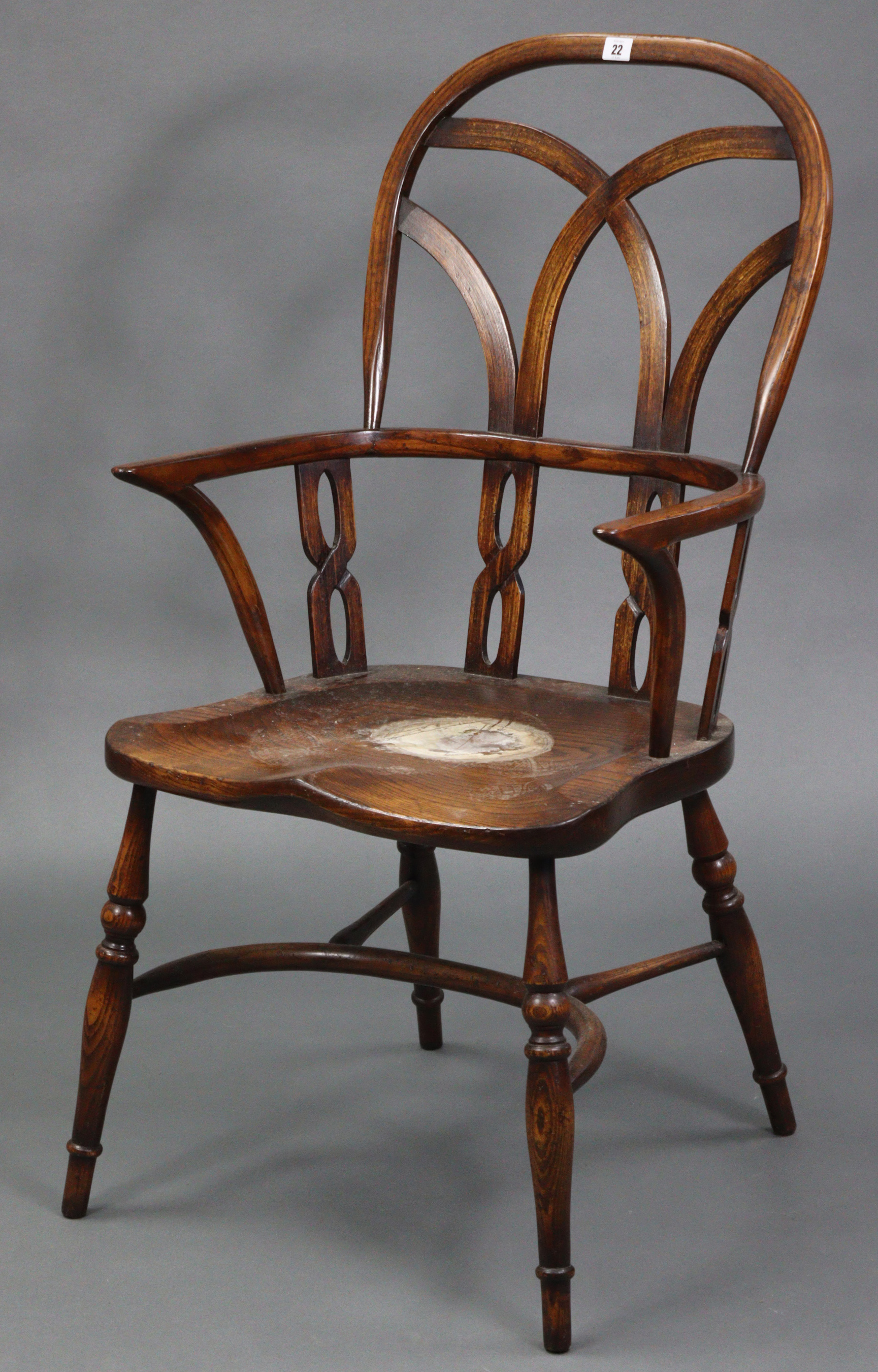 A Windsor-style ash & elm carver chair with pierced & shaped splats to the open back, with hard