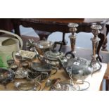 A silver plated oval entrée dish; a pair of silver plated candlesticks; two silver plated teapots of