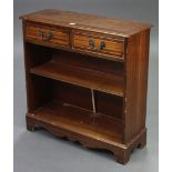 A reproduction inlaid-mahogany dwarf standing bookcase, fitted two frieze drawers above an