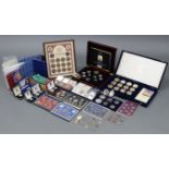 A collection of GB & Commonwealth coin sets, including an Alderney silver proof £5; pairs of