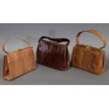 A crocodile skin ladies’ handbag; & two snake-skin ladies’ handbags, each with gilt-metal clasp.