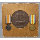A First World War bronze memorial plaque for (Private) Samuel Fox, mounted for display together with