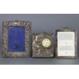 An Edwardian silver embossed bedside clock “Wake Up”, 5¾” x 4¾” London 1909; & two silver