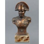 A bronzed bust of Napoleon mounted on an onyx plinth, 8” high (overall).