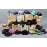 Eighteen various mid-20th century ladies’ hats; together with twelve various cardboard hat boxes.