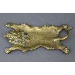 A Victorian cast-brass novelty pen-tray in the form of a lion-skin rug, 7¼” x 3¾”.