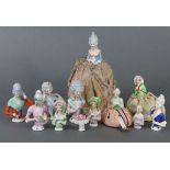A collection of twelve porcelain pin-cushion dolls, (three with pin cushions) – various sizes.