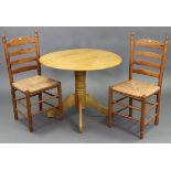 A maple-finish circular drop-leaf breakfast kitchen table on turned centre column & four cabriole