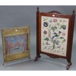 An early 20th century mahogany-frame fire screen inset needlework floral panel, 25” wide x 37½”