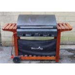 A Billyoh 4-Burner gas-operated barbeque, 57½” long, with cover.