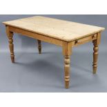 A pine kitchen table with rounded corners to the rectangular top, fitted end drawer, & on four