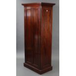 A mahogany tall hall cupboard with moulded cornice, enclosed by panel door, with panelled sides, &