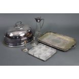 A silver plated domed meat dish cover, 18” wide x 10½” high; a pair of silver plated candlesticks,