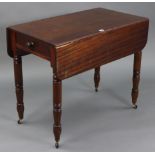 A 19th century mahogany Pembroke table fitted end drawer, & on turned & tapered legs with ceramic