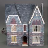 A painted wooden two-storey doll’s house with opening front, 31½” wide x 34¾” high x 15” deep, conta