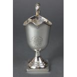 A George III silver helmet-shaped cream jug with beaded rim, loop handle, engraved monogram, & on