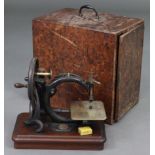 A Wilcox & Gibbs hand-crank sewing machine, on wooden plinth base, 12½” wide x 11½” high, in
