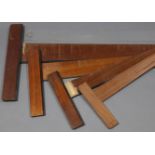 Four early-mid 20th century wooden set squares, the largest 57” long.
