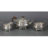 An Edwardian three-piece tea service in the regency style, of compressed oblong form with