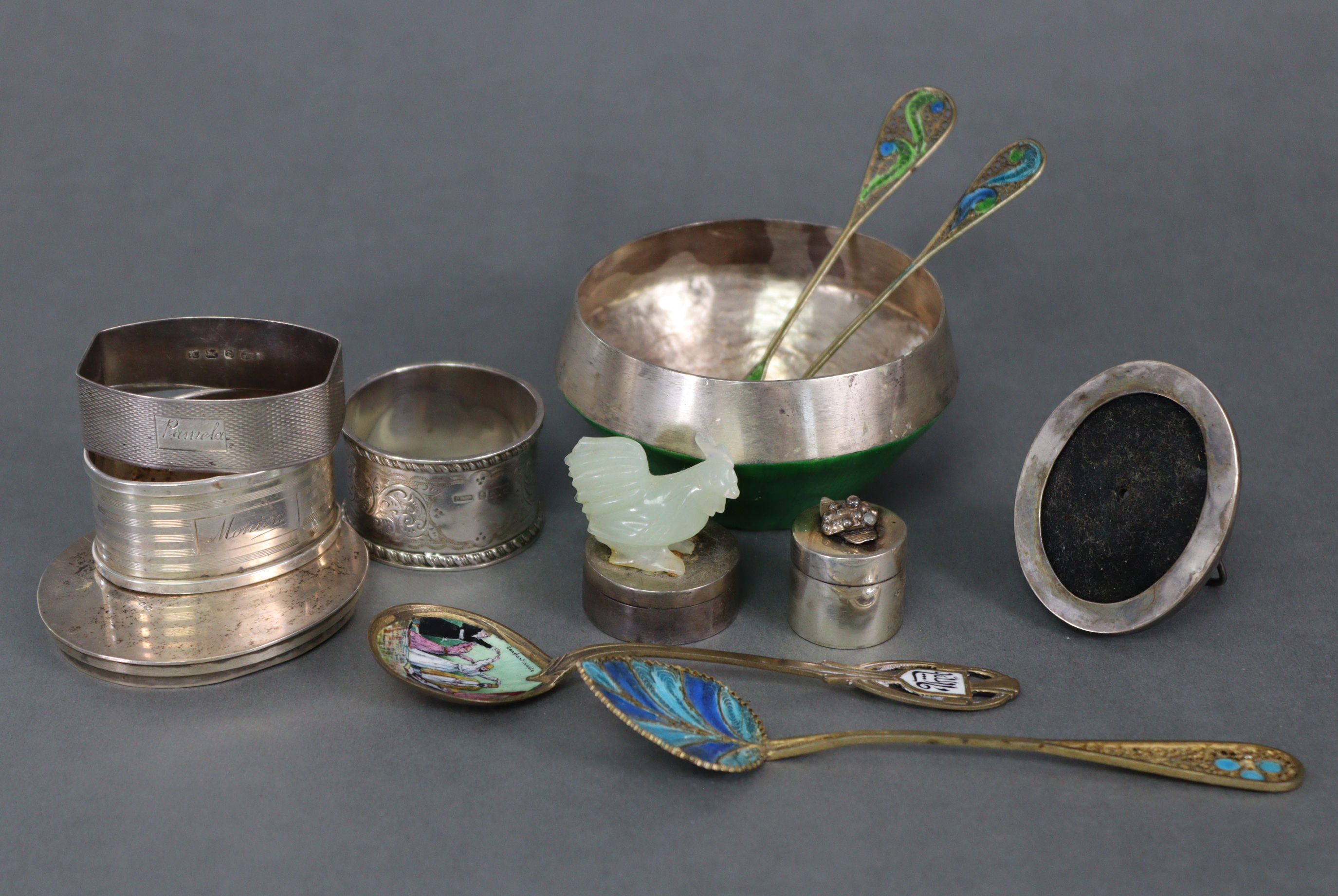 Four eastern enamelled teaspoons; a white metal & green enamelled bowl, 3” diam.; a small silver