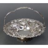 A William IV circular silver cake circular cake basket with swing handle & all-over embossed