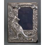 A rectangular commemorative silver photograph frame with embossed decoration depicting a kangaroo