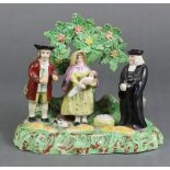 An early 19th century Staffordshire pottery “Tithe Pig” group, with the farmer, his wife & infant,