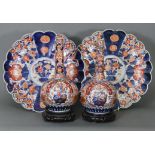A pair of 19th century Japanese Imari porcelain bottle vases, decorated with baskets of flowers in