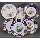 A group of six Royal Worcester cabinet plates most with shaped gadrooned gilt rims, blue