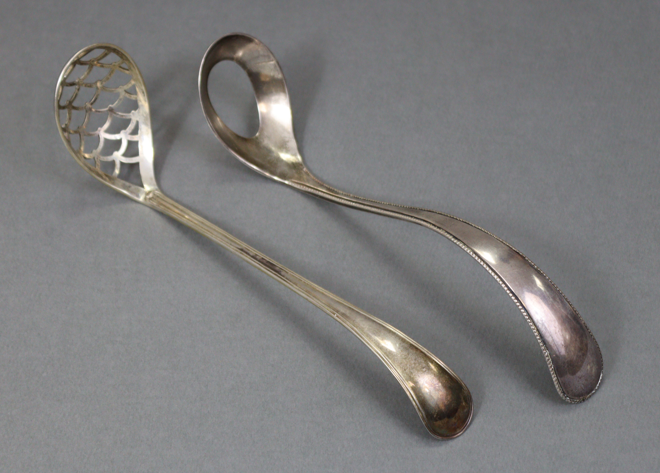 A Dutch silver .934 standard egg ladle with beaded edge to the long curved handle, 1889; & a similar