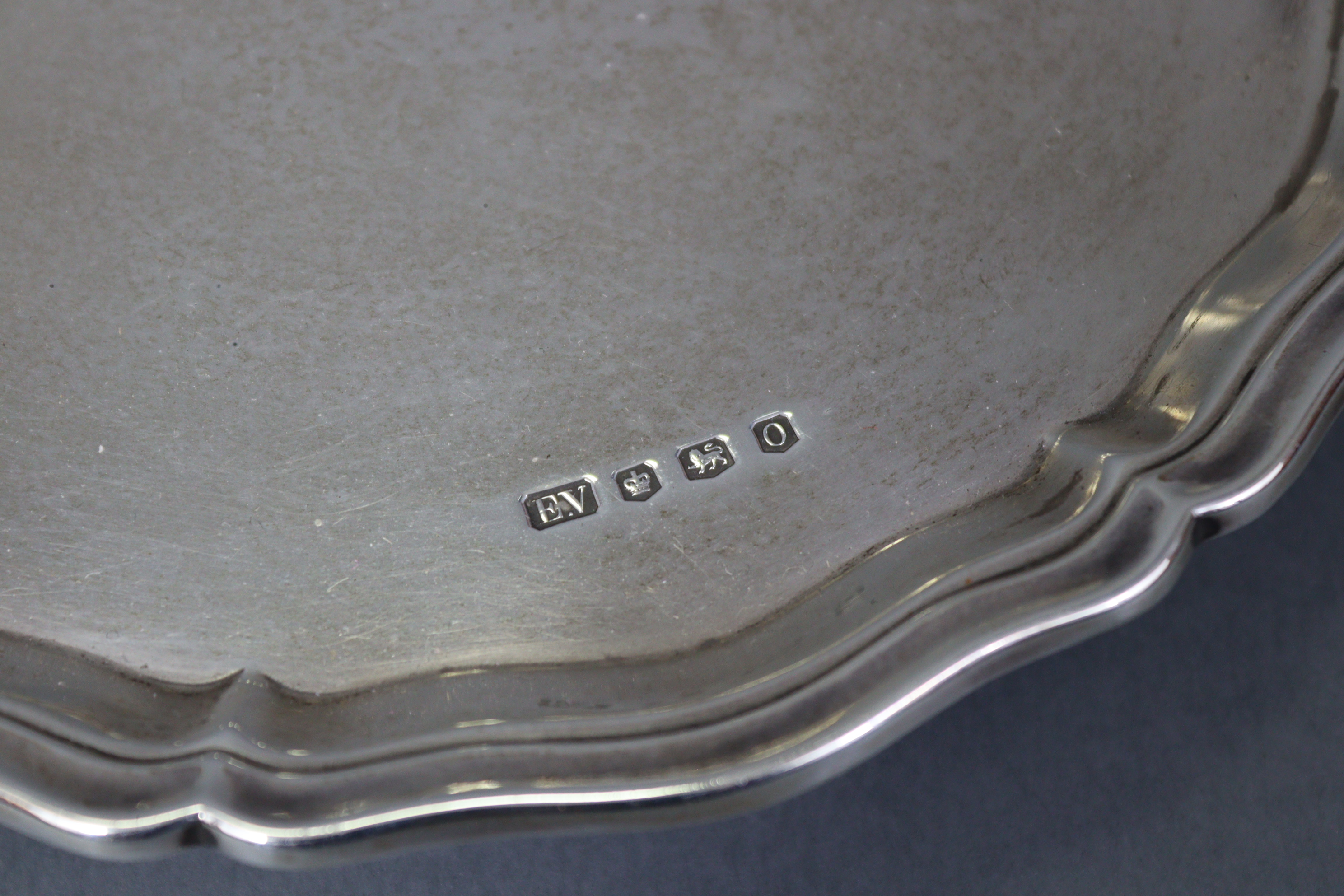 A George V silver waiter with raised pie-crust border, on three leaf-scroll feet, 8” diam.; - Image 2 of 4