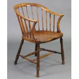 A 19th century Windsor type spindle-back tub chair with curved back & arms, hard seat & on
