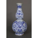 An 18th century Dutch delft double-gourd shaped bottle vase with ribbed body & all-over floral