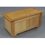 A light oak blanket box with hinged lift-lid, & with panelled sides, 39¼” wide x 17¼” high x