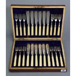 A set of twelve epns fish eaters with ivorine handles, & in fitted mahogany case.