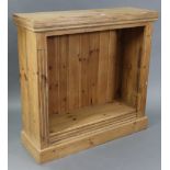 A pine small standing open bookcase with three adjustable shelves, & on plinth base, 36½” wide x