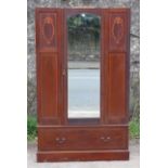A Maple & Co. Edwardian inlaid-mahogany wardrobe with moulded cornice, enclosed by rectangular beve