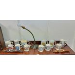A flex-arm table lamp on cast-metal base; together with twelve various commemorative mugs; & two