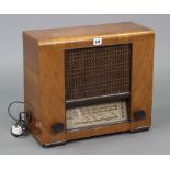 An Ultra valve radio in walnut-finish case; together with various 78 rpm records; two AVO meters;