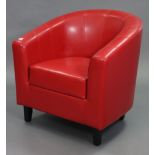 A crimson leatherette tub-shaped easy chair on ebonised wooden feet.