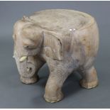 A carved hardwood novelty coffee table in the form of an elephant, 21” wide x 18½” high.