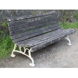A VICTORIAN GARDEN BENCH with teak slatted seat & back, & on white painted cast-iron shaped end