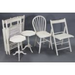 A set of four white painted wooden fold-away chairs; a white painted wooden spindle-back kitchen