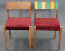 A pair of mid-century dining chairs upholstered crimson velour.