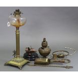 A Corinthian-style brass oil table lamp with clear-glass reservoir & with cherub figure to the
