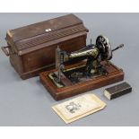 A Singer hand sewing machine with walnut case.