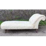 A Victorian daybed with buttoned scroll-end & sprung seat upholstered cream floral material, & on